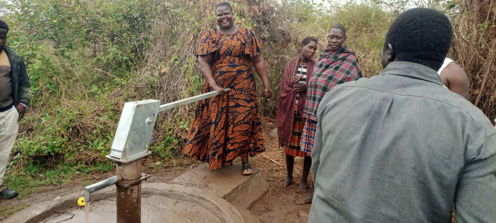 Villagers at a new water well in Uganda